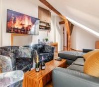 studio-like living room with TV, two leather sofas, three armchairs provides additional space.  75'' TV available with ChromeCast (YouTube, Spotify, Netflix, etc.)