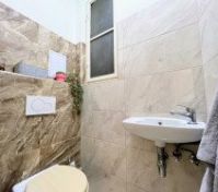 Separate toilet with small sink
