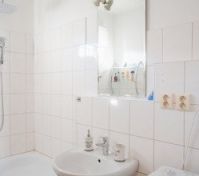 White bathroom with tub and sink
