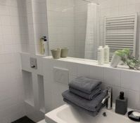 Clean white bathroom with shower
