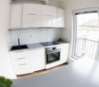 White kitchen with oven and balcony