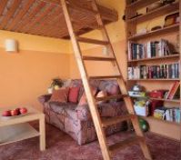 The double loft bed is accesed by a ladder