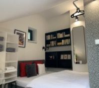 Bed with bookshelf and mirror