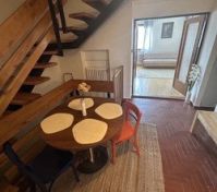 Dining area with wooden staircase