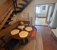 Dining area with wooden staircase