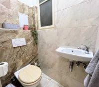 Toilet room with sink