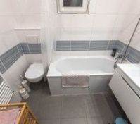 Full bathroom with tub and toilet
