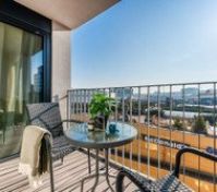 A cozy balcony with stylish seating, a glass-top table, and a relaxing atmosphere. Enjoy a morning coffee or unwind with a sunset view in this peaceful outdoor space. Perfect for fresh air and city views.