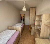 Twin bedroom with wooden furniture