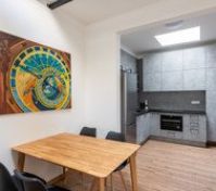Dining area with kitchen and artwork