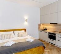 Studio bed with kitchenette beside