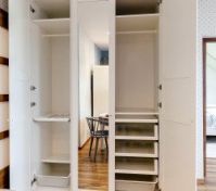 Open white wardrobe with mirror