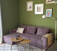 Living room green wall purple sofa
