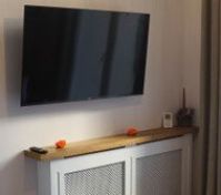 Wall-mounted TV on radiator cover