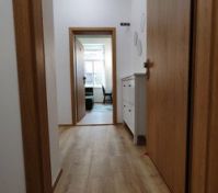 Entrance view, with private outdoor space for shoes and mirror