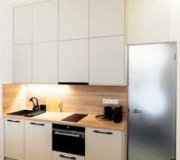 Modern kitchenette with oven and cabinets