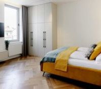 Spacious bedroom with wardrobe and TV