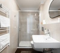 Bathroom with shower and towel rack