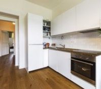 White kitchen with oven fridge