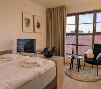 Bedroom with city rooftop view