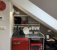 Compact kitchenette with red fridge