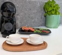 Coffee machine with cups on counter