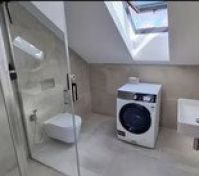Bathroom with shower and washer